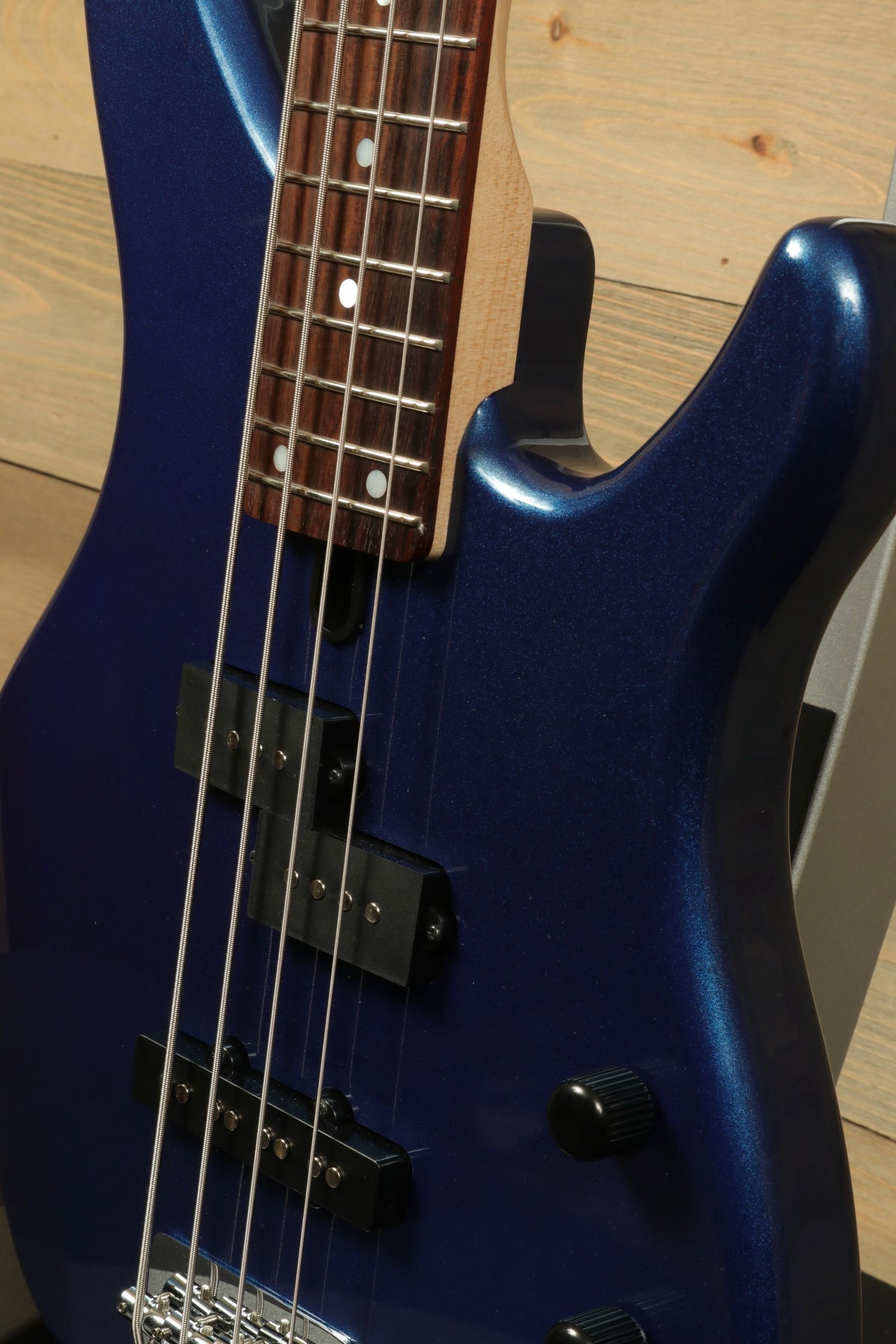Yamaha TRBX174 electric bass guitar in blue metallic finish, close-up side view