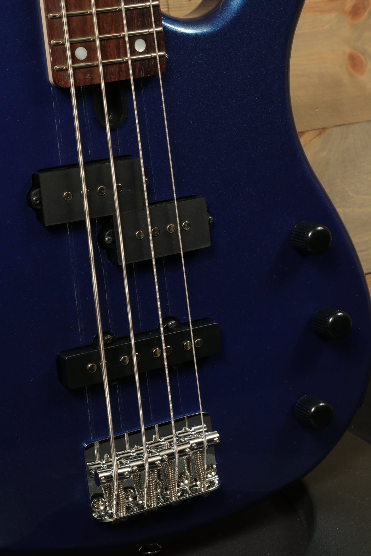 Yamaha TRBX174 bass guitar in deep blue finish, close-up view of the pickups and bridge