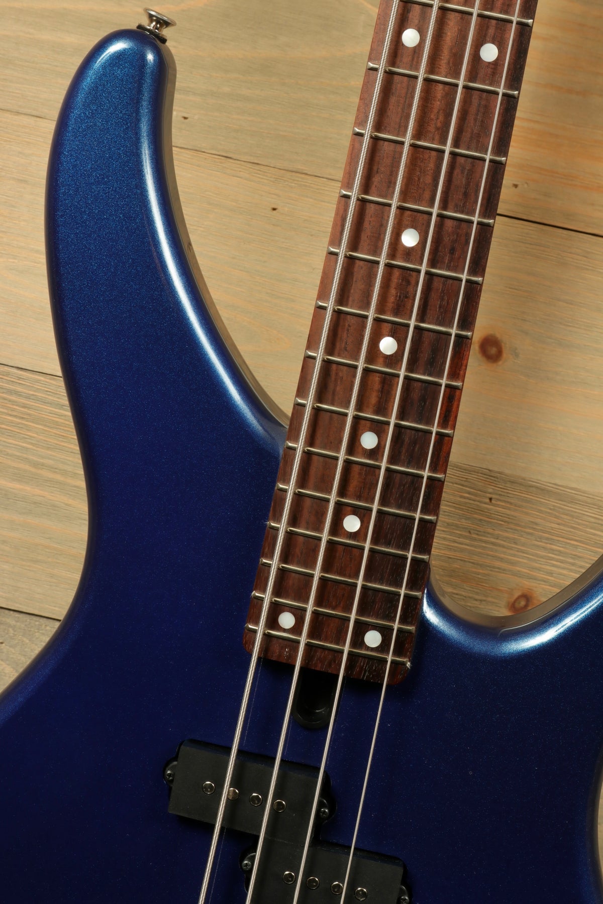 Yamaha TRBX174 electric bass guitar in blue with a smooth finish, top view showcasing fingerboard and frets