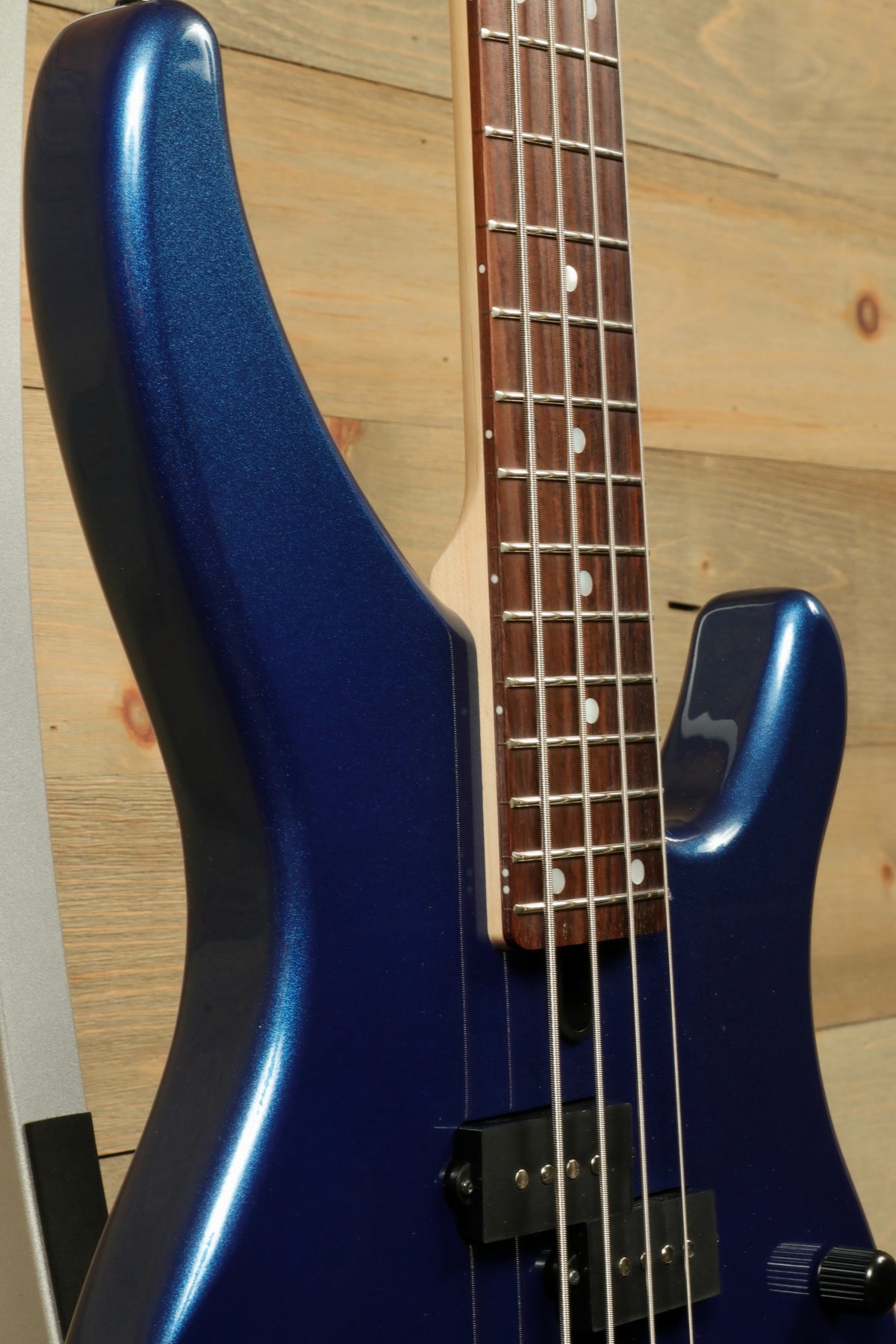 Yamaha TRBX174 electric bass guitar in blue, close-up view showcasing the body and neck