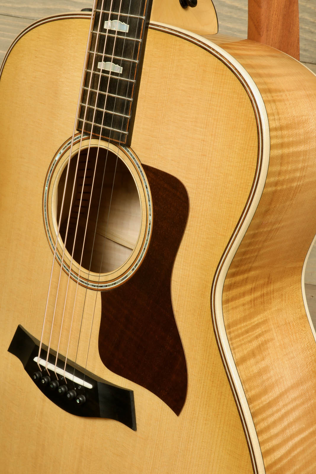 a close up of a guitar with a wooden back and sides