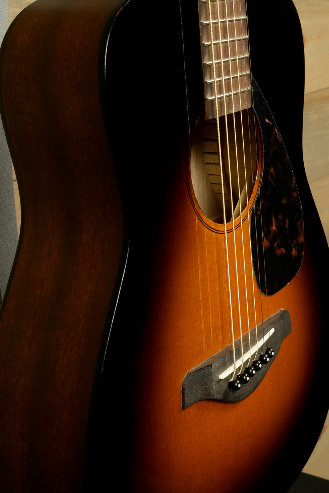 Yamaha acoustic guitar in sunburst finish, side view showcasing craftsmanship and details