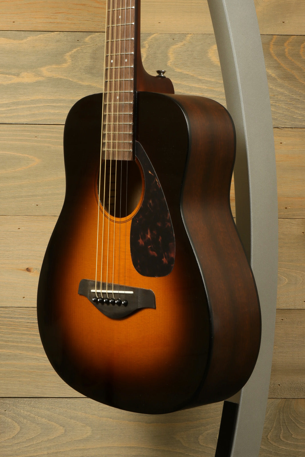 Yamaha acoustic guitar, sunburst finish, side view showcasing rich wood grain