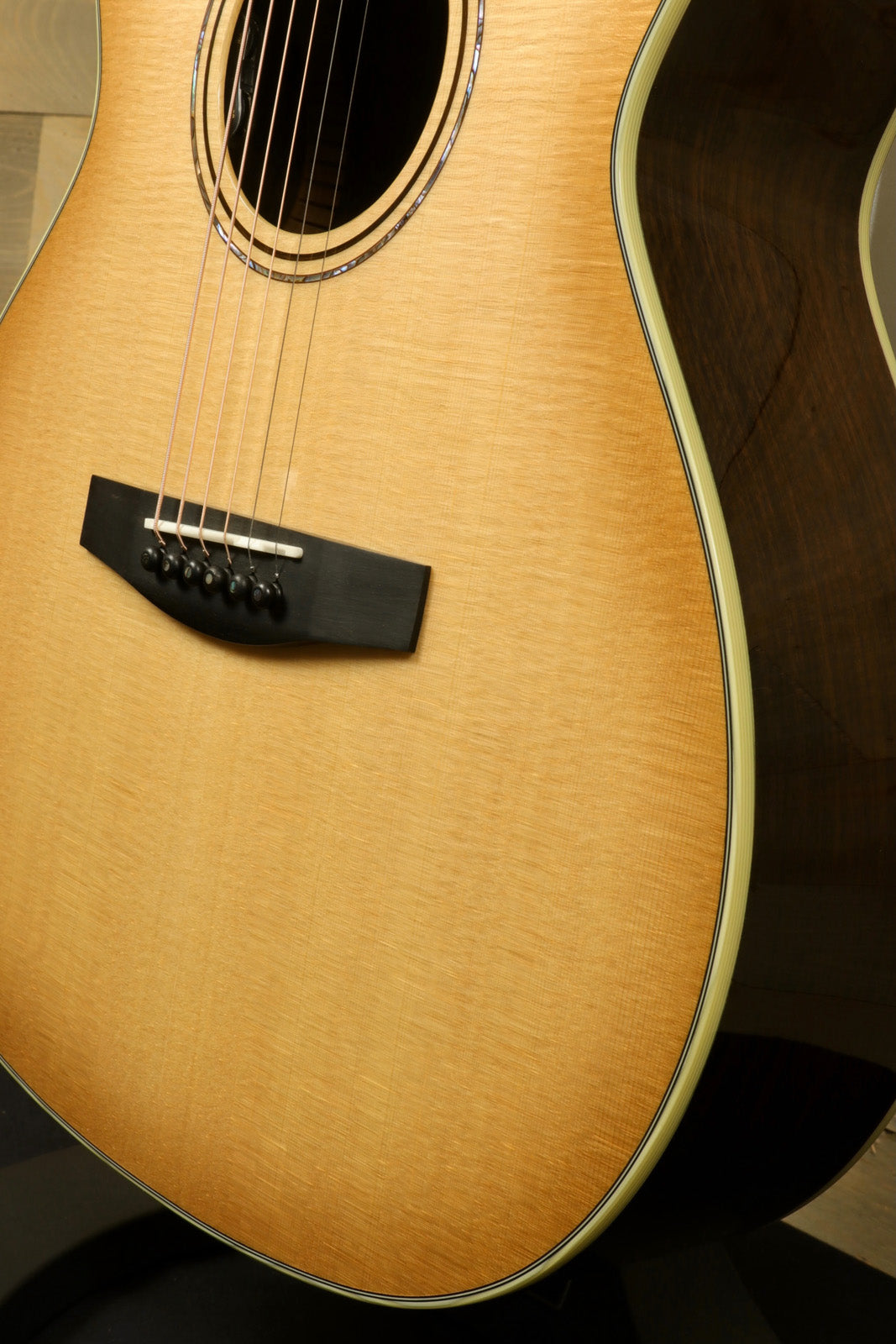 Alvarez LF70e Daybreak acoustic electric guitar, natural finish, side view highlighting the body and soundhole