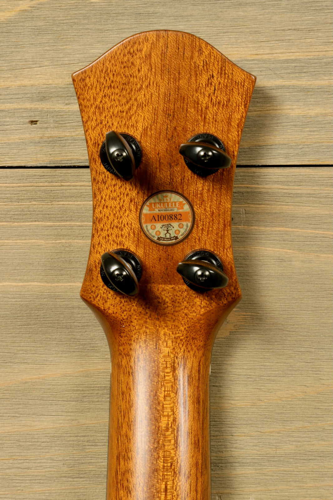 ANueNue UT200 ukulele neck in natural wood finish, back view showcasing tuning pegs