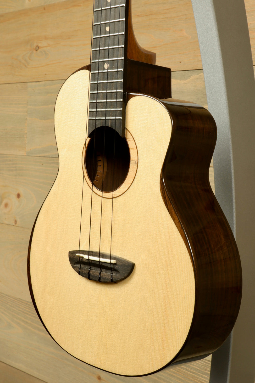 ANueNue UT200 Ukulele with a natural finish, side view highlighting the smooth grain and craftsmanship