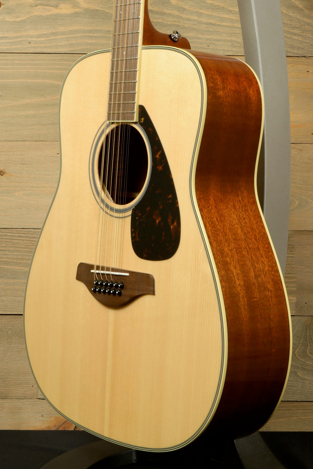 Yamaha acoustic guitar natural finish with glossy body, side view