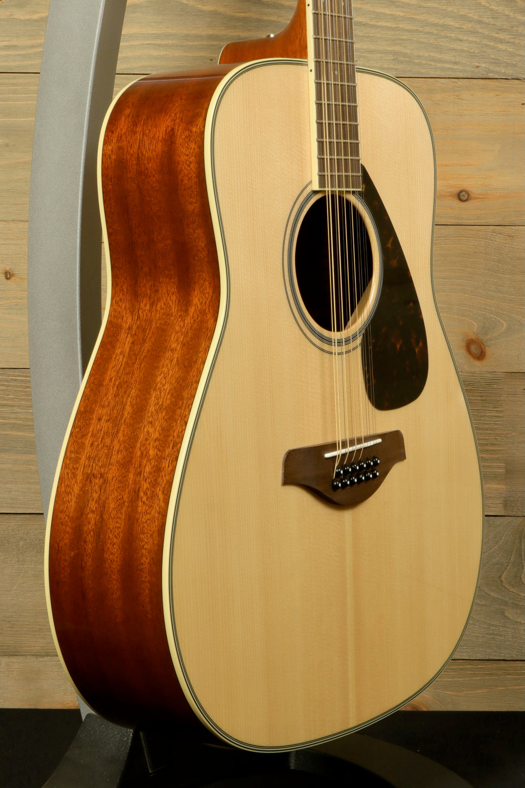 Yamaha acoustic guitar acoustic guitar with a natural finish, side view showcasing the detailed wood grain