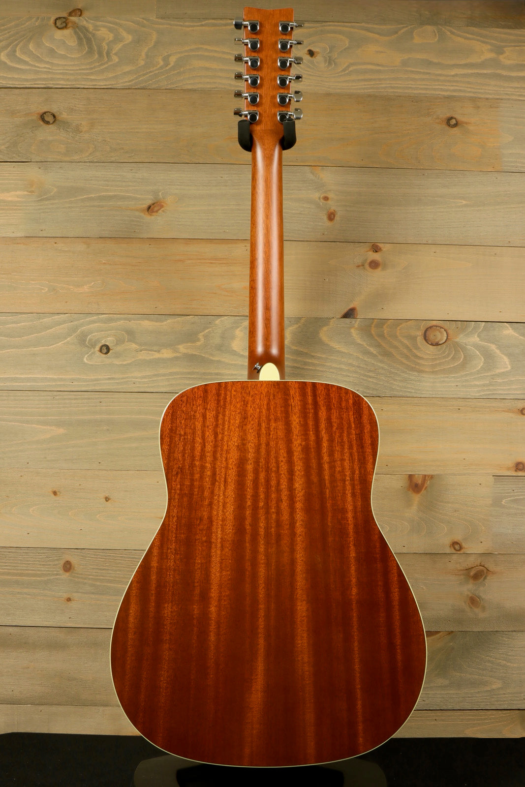 Yamaha acoustic guitar, natural wood finish, back view with detailed grain pattern