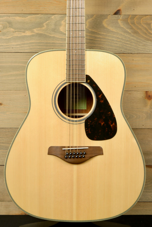 Yamaha acoustic guitar, natural finish, front view showcasing the body and neck