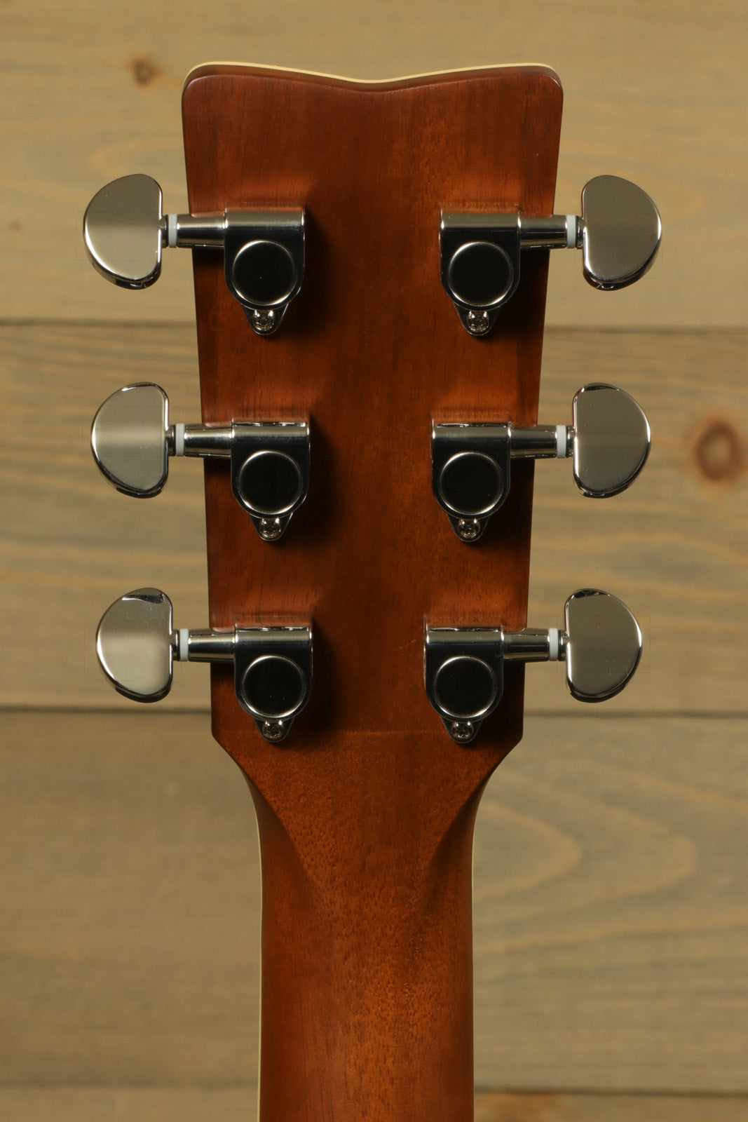 Yamaha acoustic electric guitar, mahogany back, showcasing the tuning pegs from the rear view