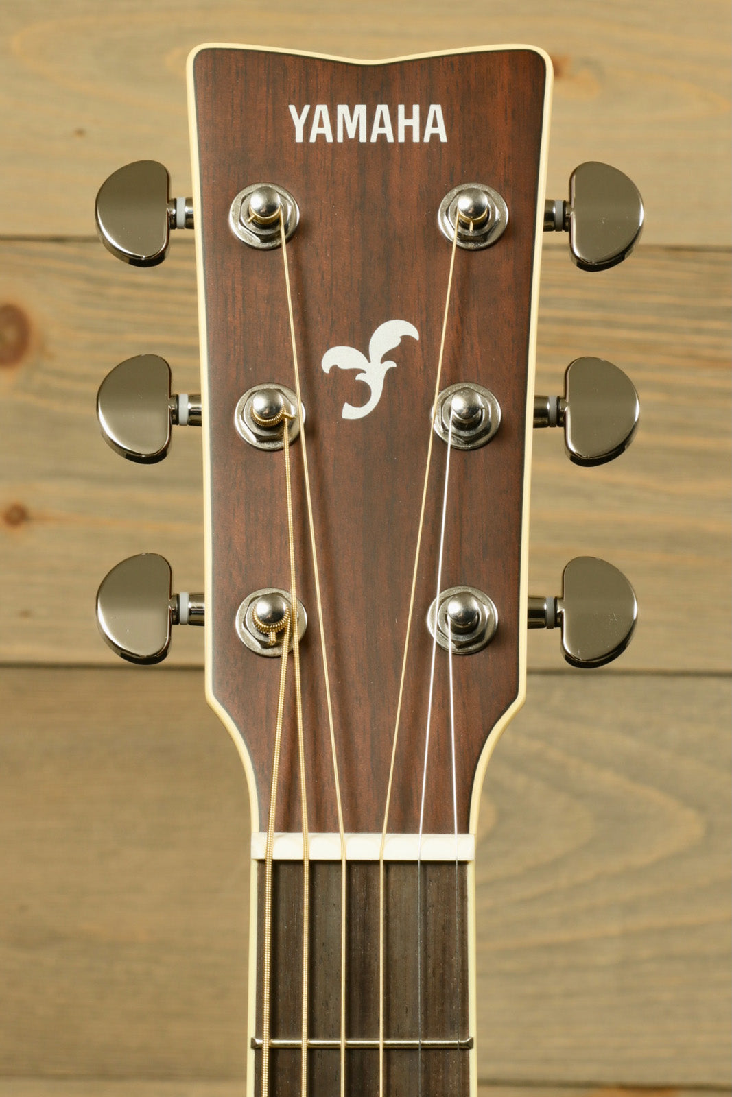 Yamaha acoustic guitars electric, headstock view showcasing tuning pegs and logo