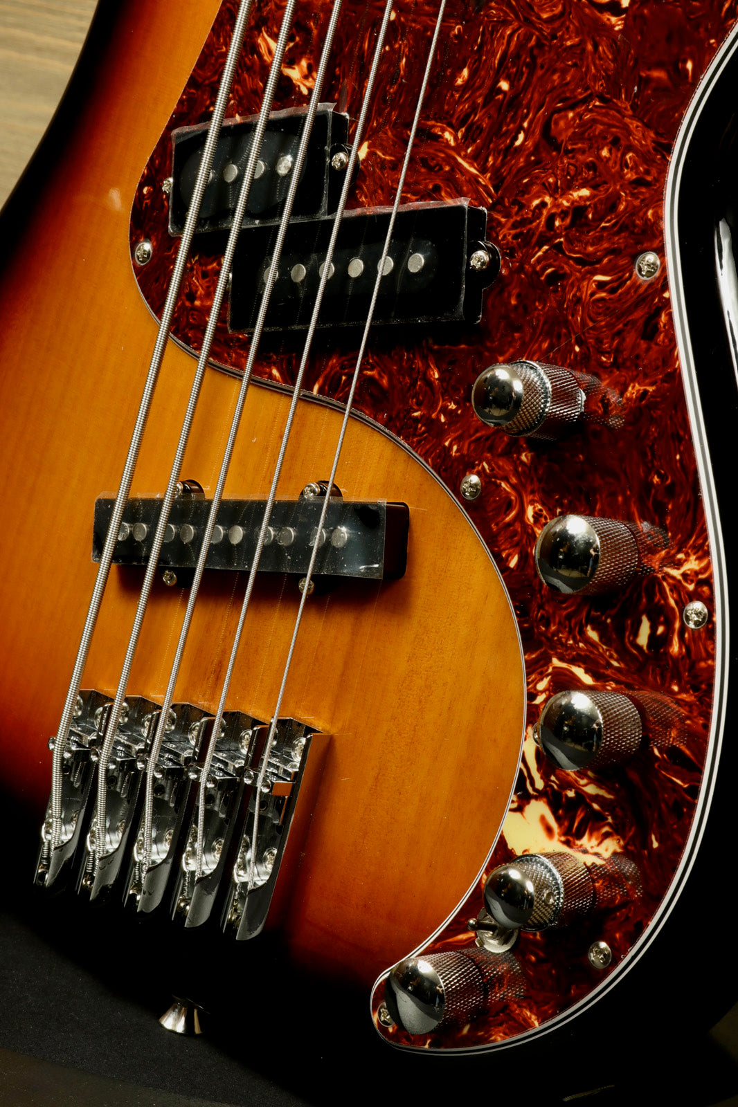 Tagima bass guitar 5 string with sunburst finish and chrome hardware, close-up view