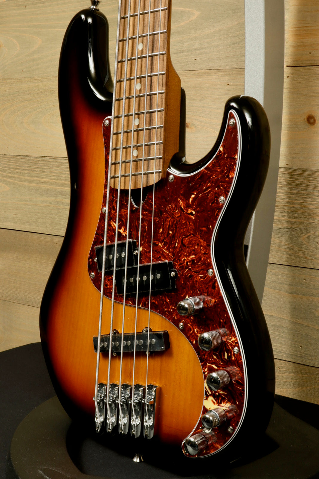 Tagima bass guitar 5 string in sunburst finish, front view showcasing sleek body design