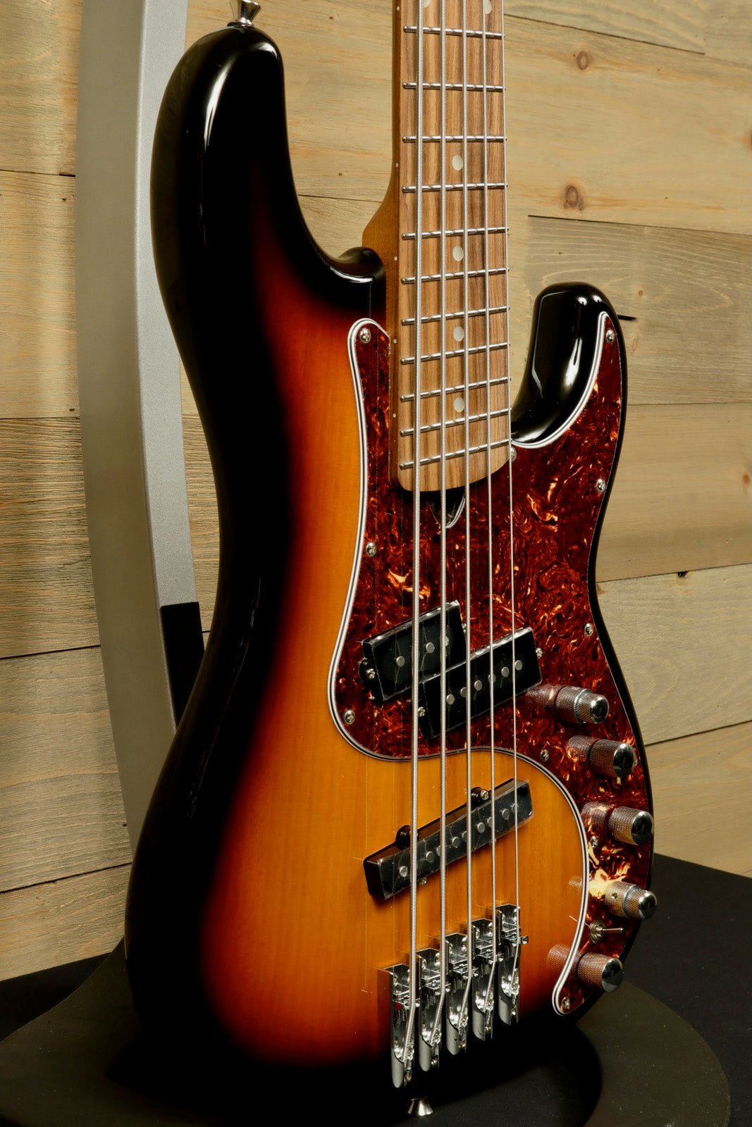 Tagima bass guitar 5 string in sunburst finish, side view showcasing its smooth contours