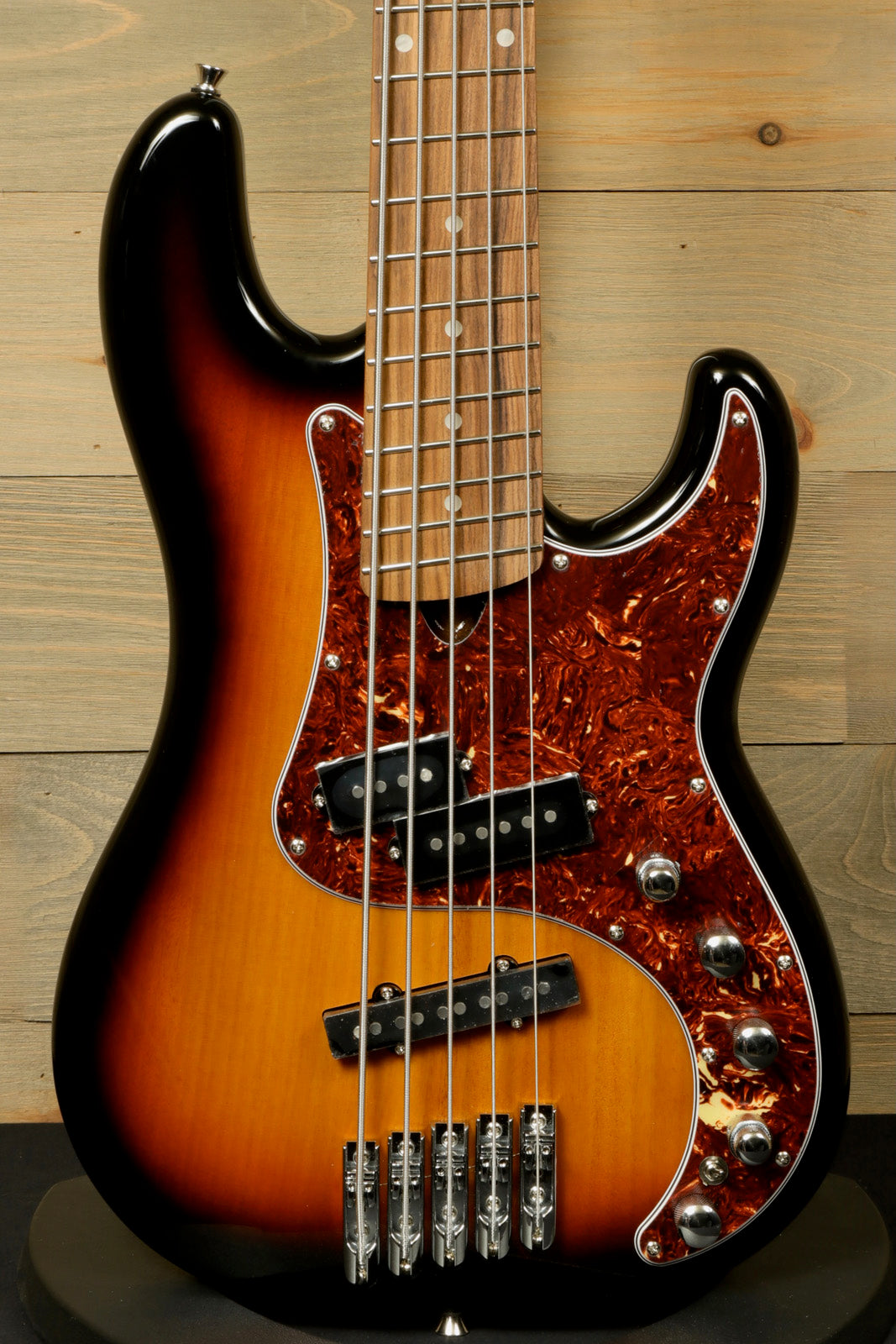 Tagima bass guitar 5 string in sunburst finish, front view with tortoiseshell pickguard