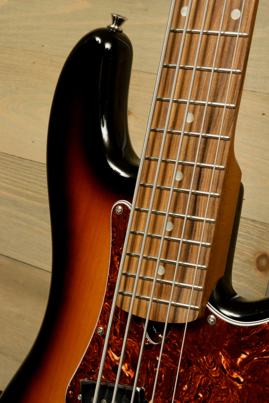 Tagima 5 string bass guitar with sunburst finish and rosewood fretboard, close-up view