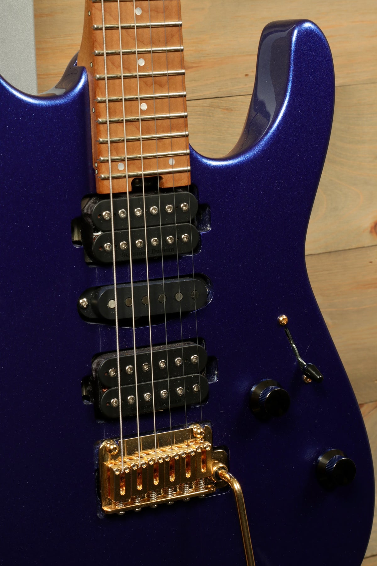 Charvel Pro-Mod DK24 HSH electric guitar in metallic blue, close-up view of pickups and bridge