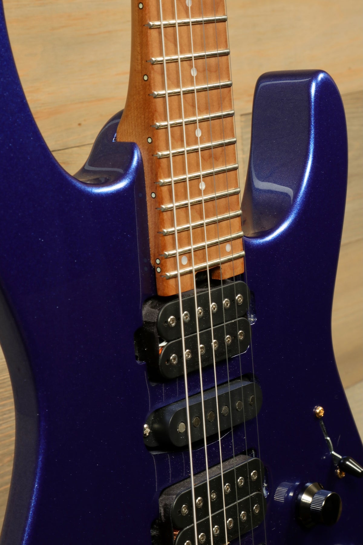 Charvel Pro-Mod DK24 HSH electric guitar in purple finish, close-up view of the body and neck