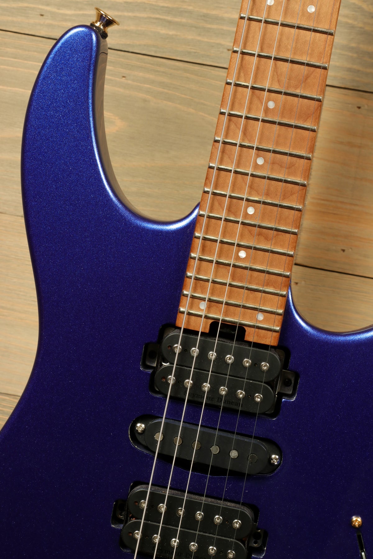 Charvel Pro-Mod DK24 HSH electric guitar in purple, close-up view of the neck and pickups