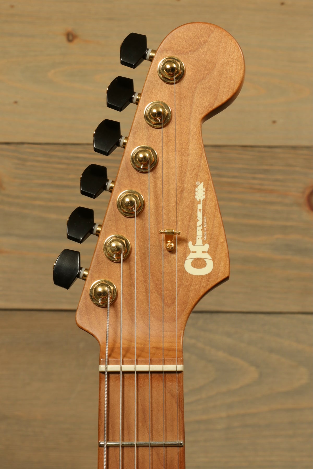 Charvel Pro-Mod DK24 HSH electric guitar, natural wood finish, headstock view
