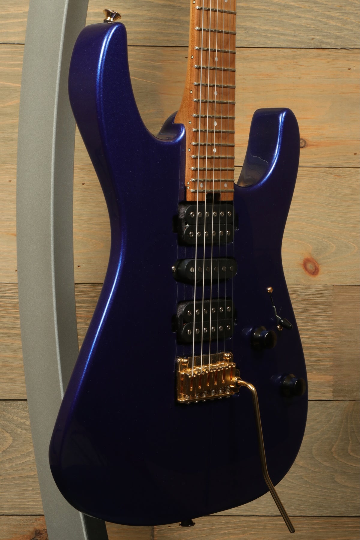 Charvel Pro-Mod DK24 HSH electric guitar in vibrant purple, side view showcasing design and features