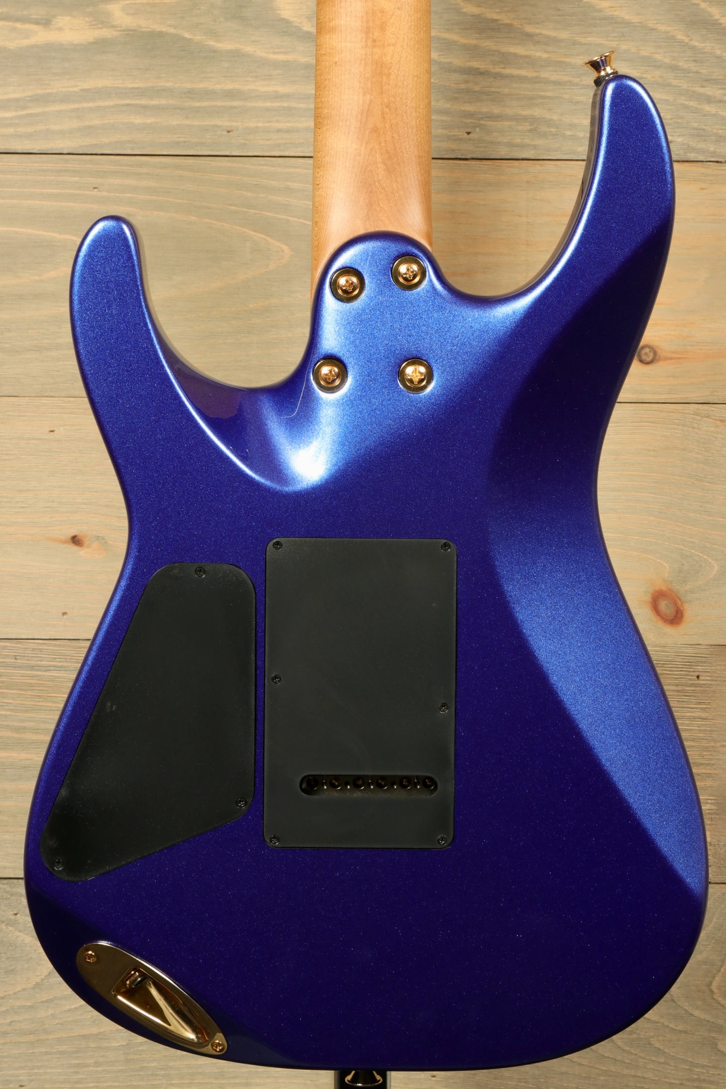 Back view of Charvel Pro-Mod DK24 Mystic Blue guitar showcasing the sleek finish and hardware.