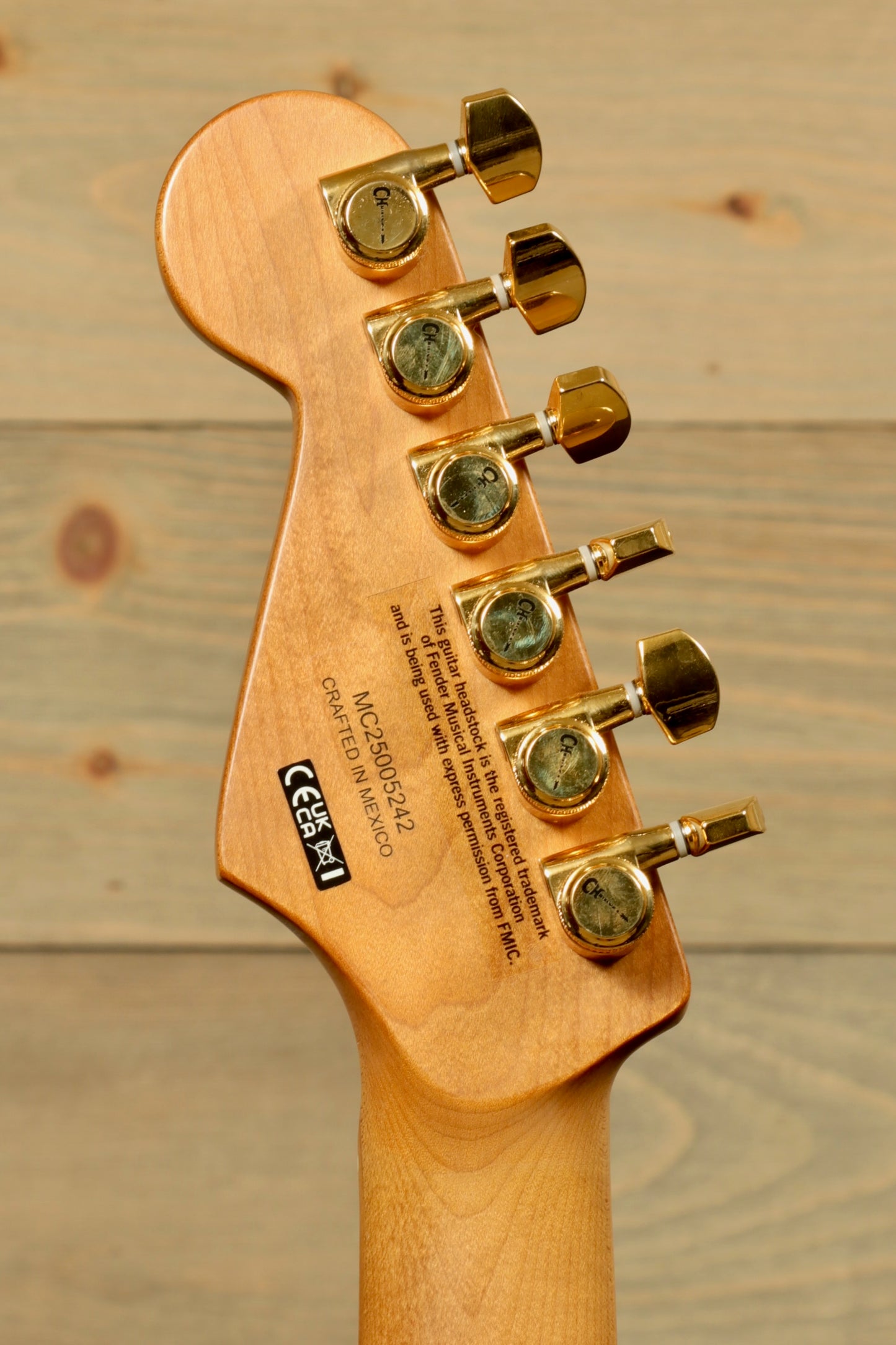 Back view of Charvel Pro-Mod DK24 Mystic Blue guitar showcasing the tuning pegs and unique wood grain