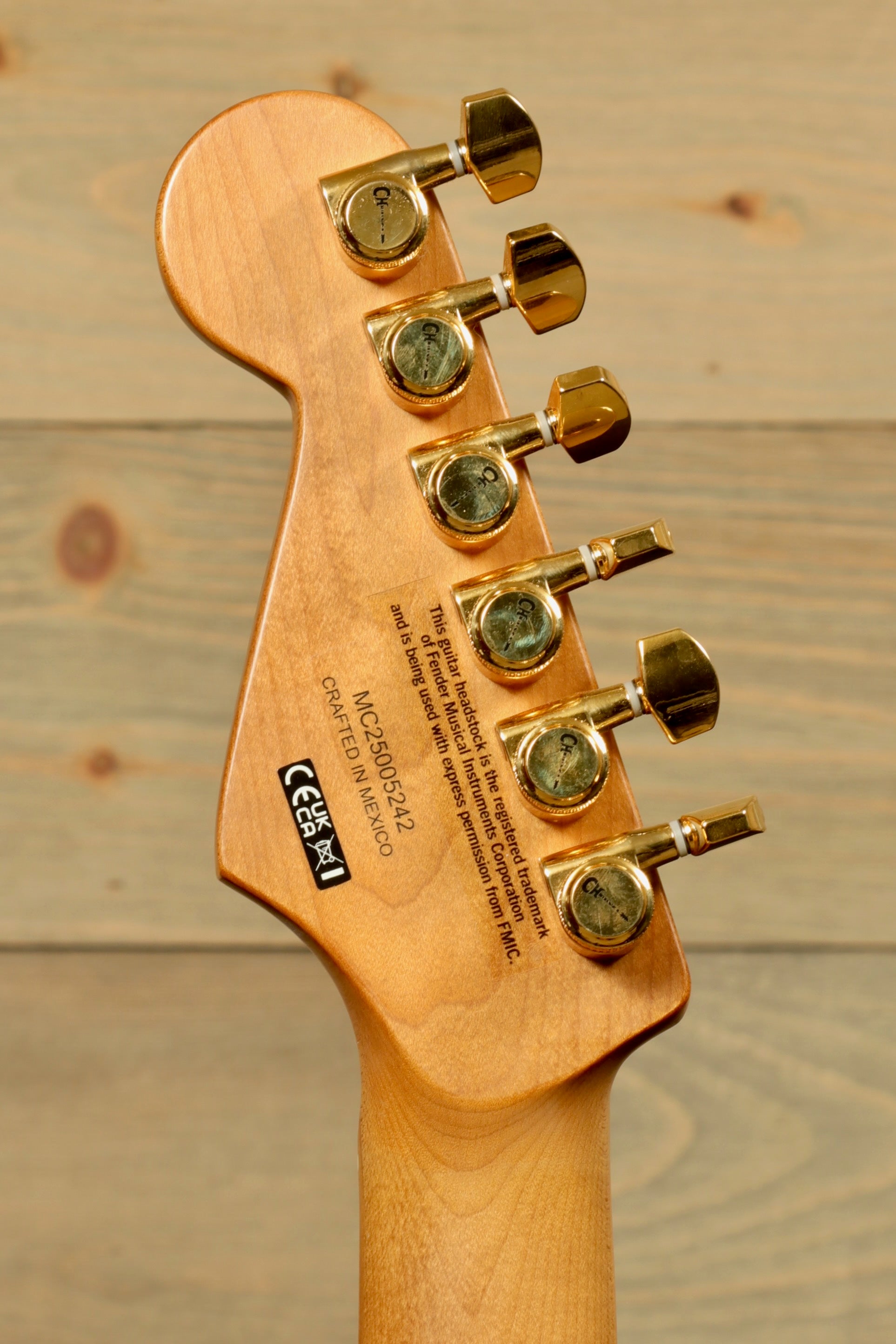 Back view of Charvel Pro-Mod DK24 Mystic Blue guitar showcasing the tuning pegs and unique wood grain