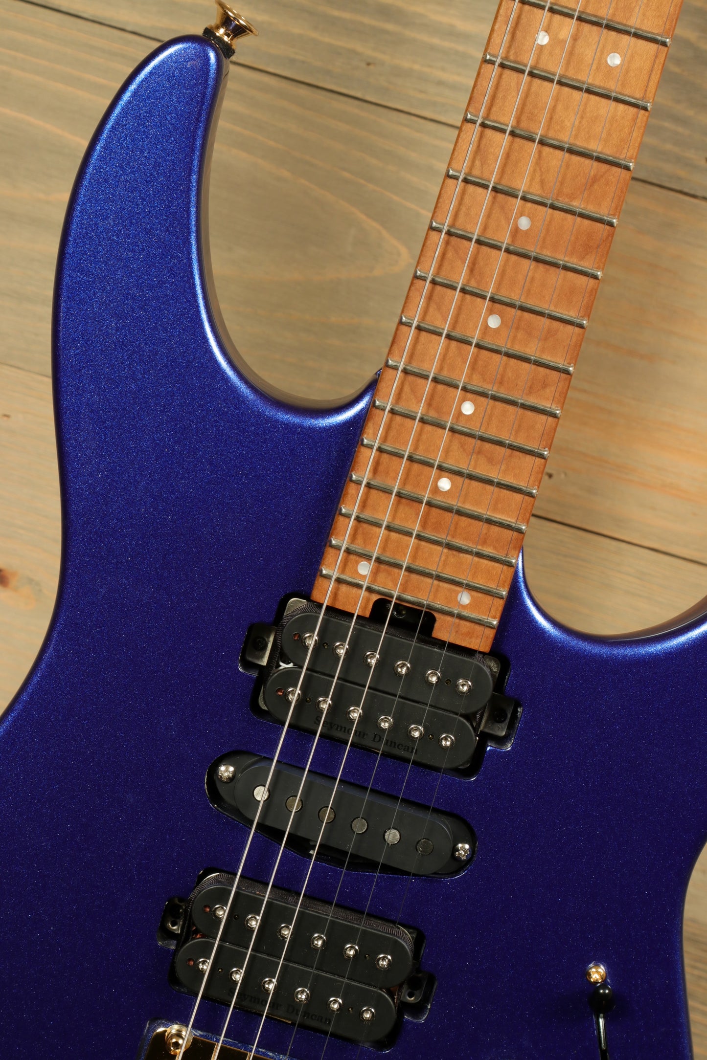 Charvel Pro-Mod DK24 Mystic Blue guitar featuring a sleek design and three pickups