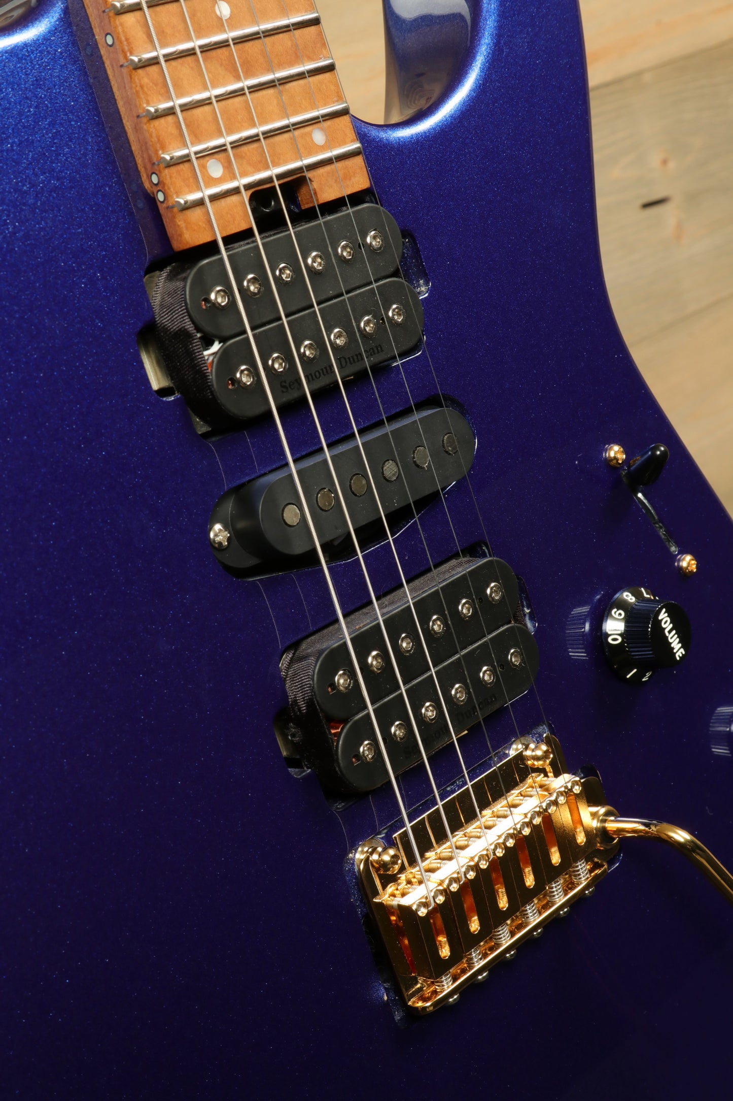 Close-up of Charvel Pro-Mod DK24 Mystic Blue guitar featuring dual pick-ups and gold hardware