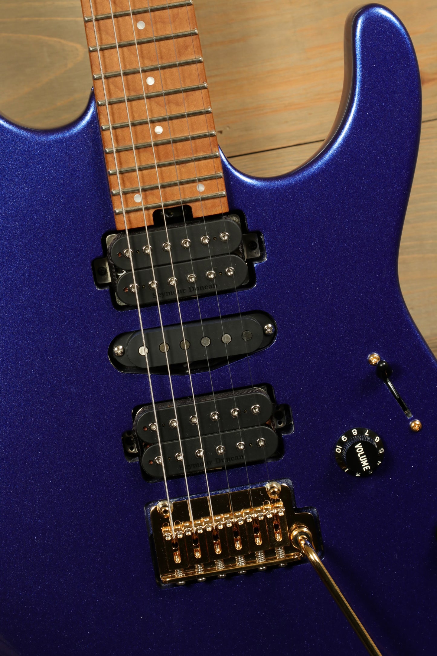 Charvel Pro-Mod DK24 Mystic Blue guitar featuring a sleek body, dual humbuckers, and gold hardware