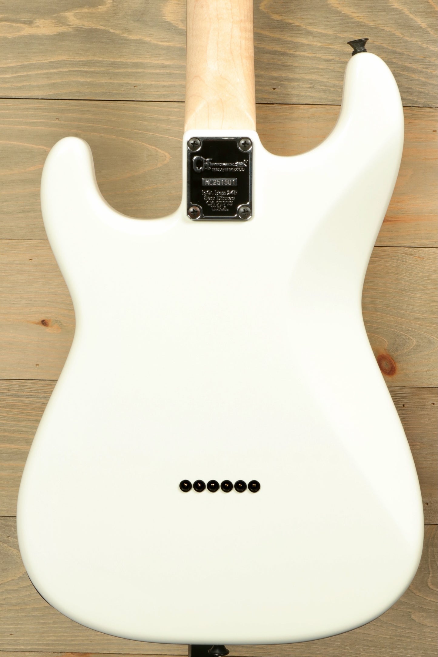 Back view of Charvel Pro-Mod So-Cal electric guitar in white finish with sleek design and tonal control knobs