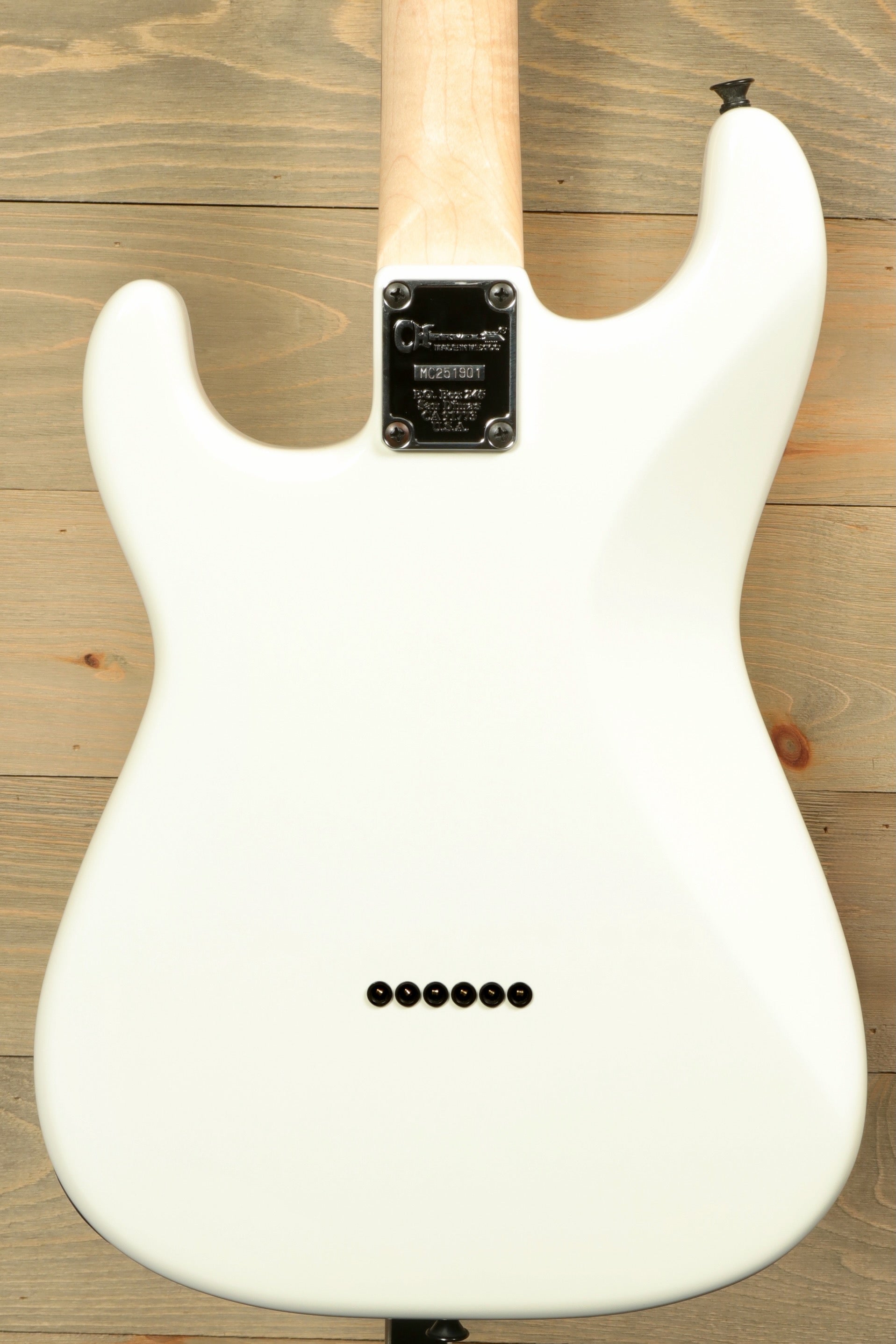 Back view of Charvel Pro-Mod So-Cal electric guitar in white finish with sleek design and tonal control knobs
