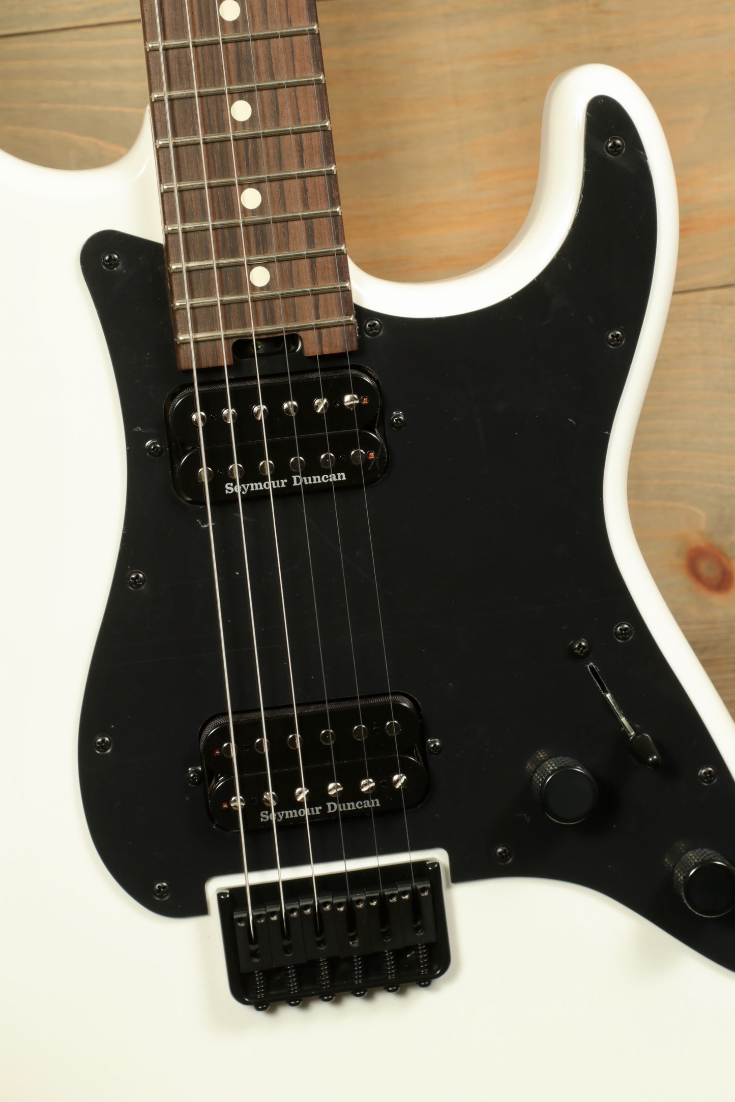 Charvel Pro-Mod So-Cal electric guitar with a sleek white body and black hardware