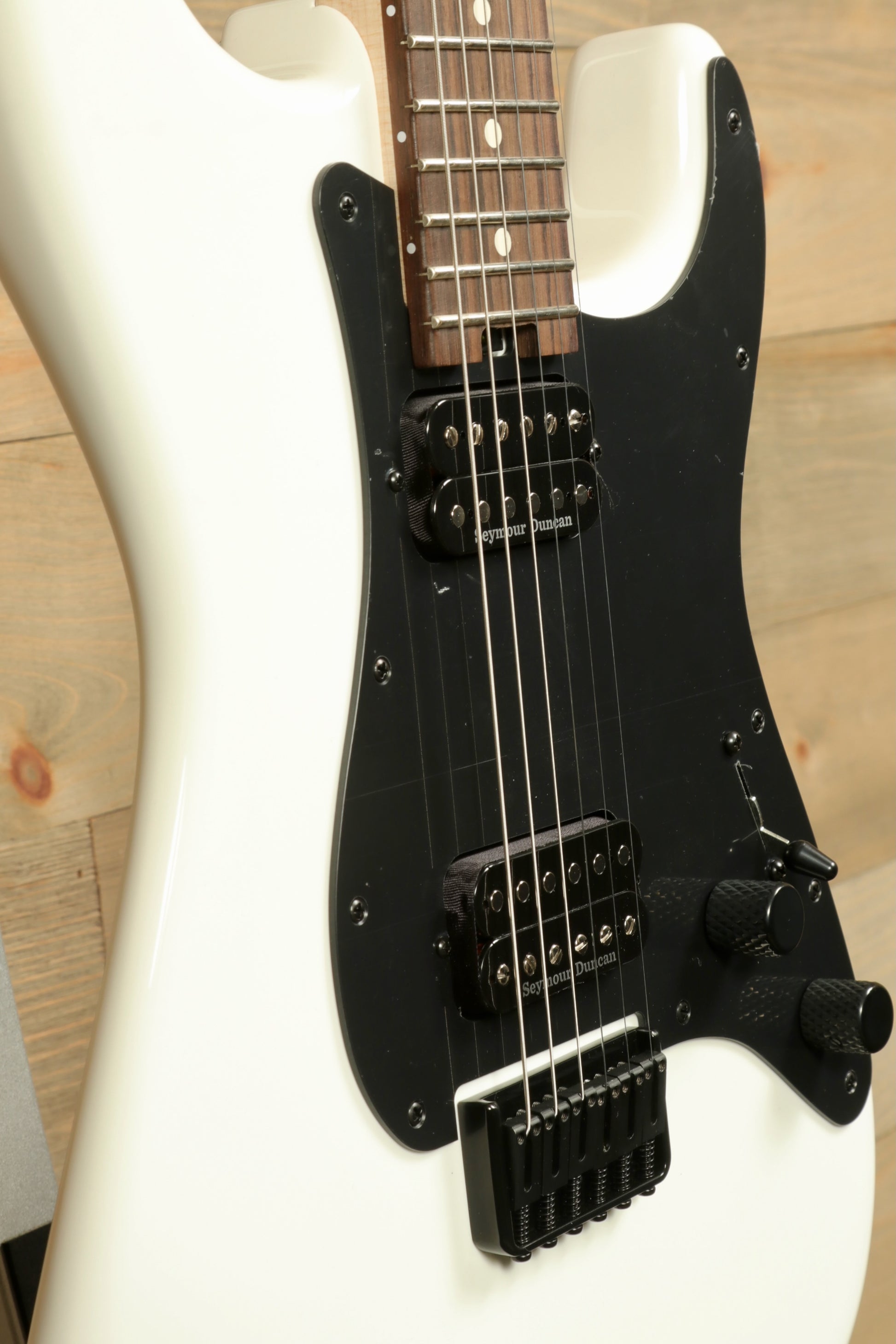 Charvel Pro-Mod So-Cal electric guitar in white with black pickguard and sleek design