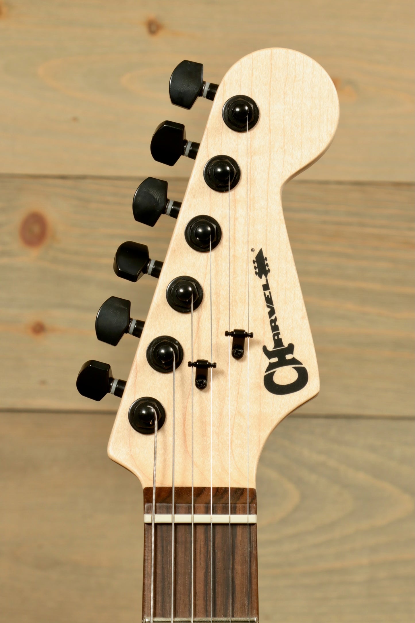 Charvel Pro-Mod So-Cal electric guitar headstock with black tuners and sleek design