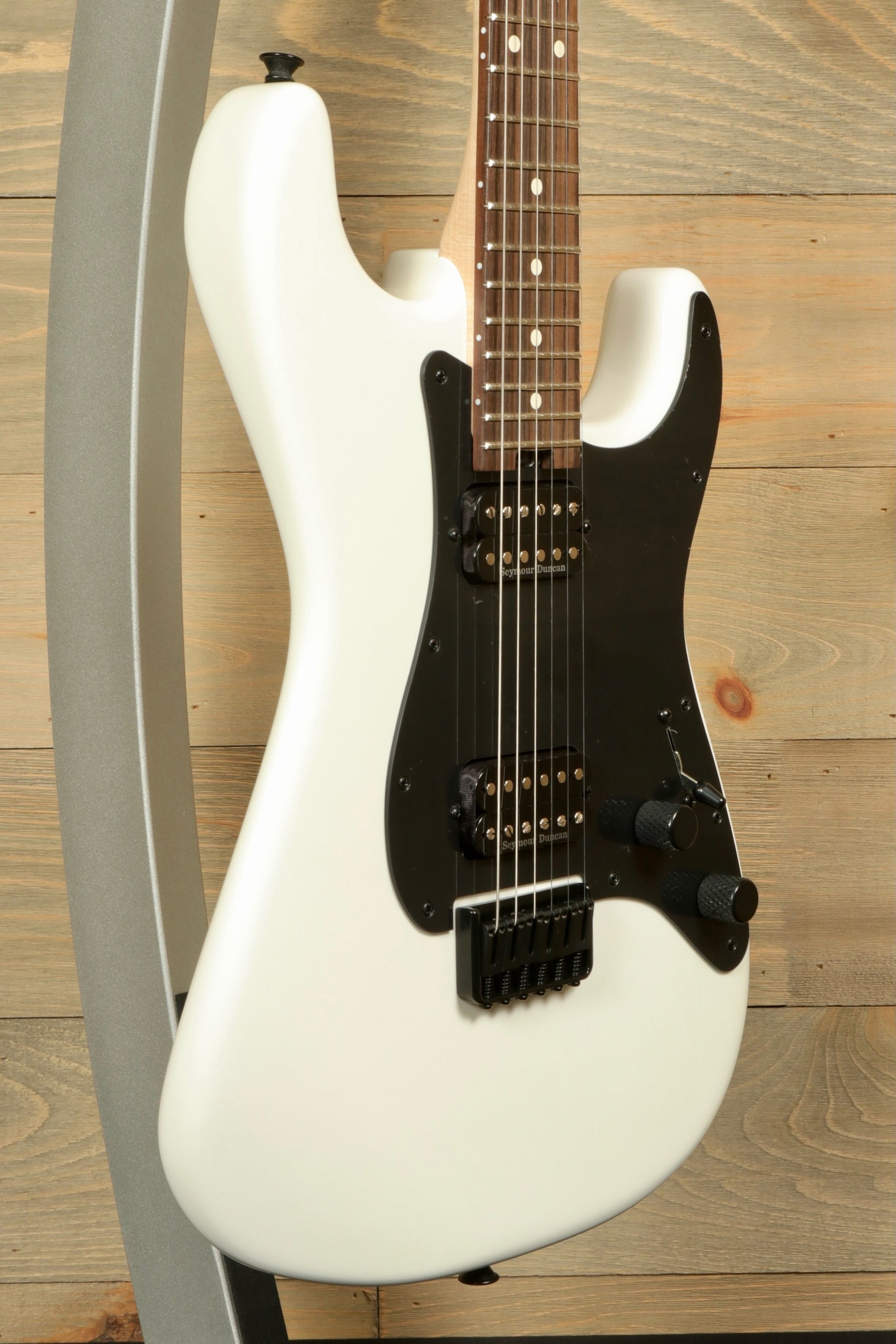 Charvel Pro-Mod So-Cal electric guitar in gloss white finish with black hardware and a sleek design