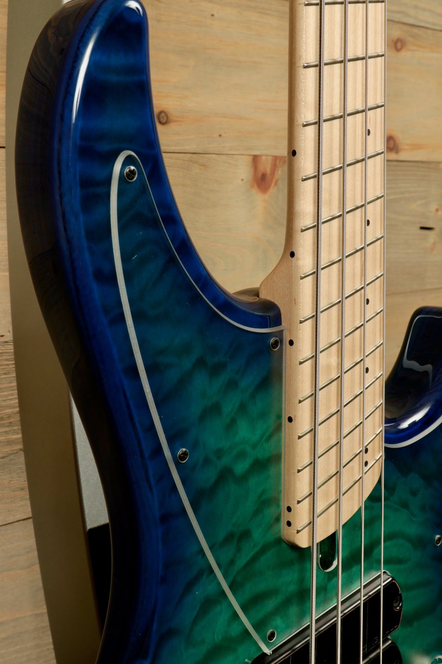 Dingwall Combustion Nashville bass guitar with a blue to green burst finish, side view showcasing the quilted top