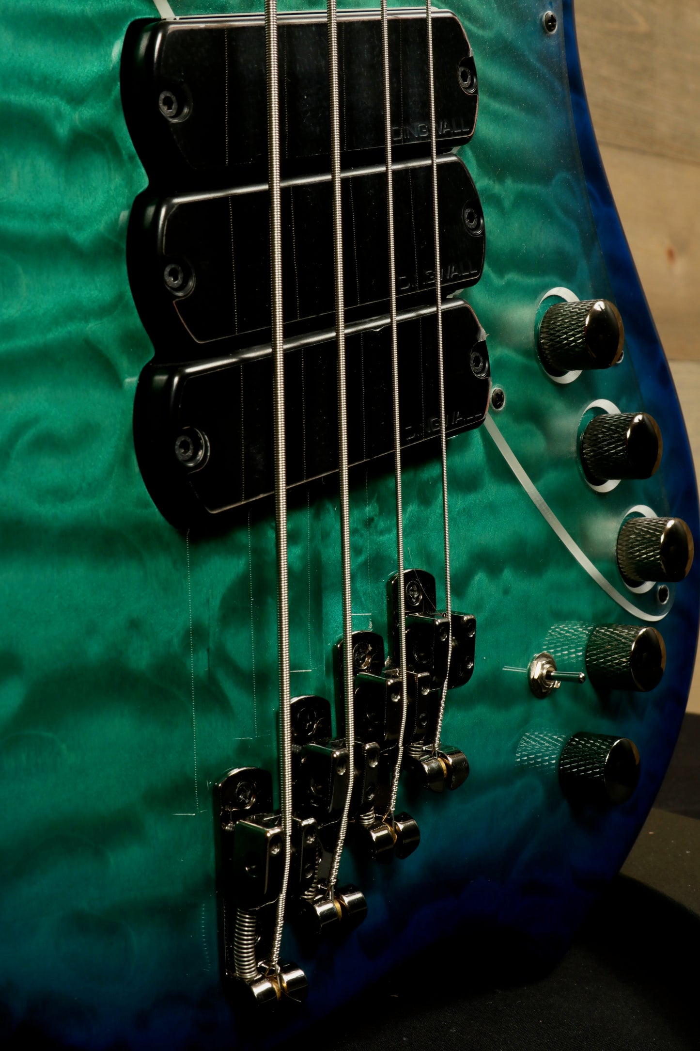 Dingwall Combustion Nashville bass guitar in teal quilted finish, angled front view highlighting hardware