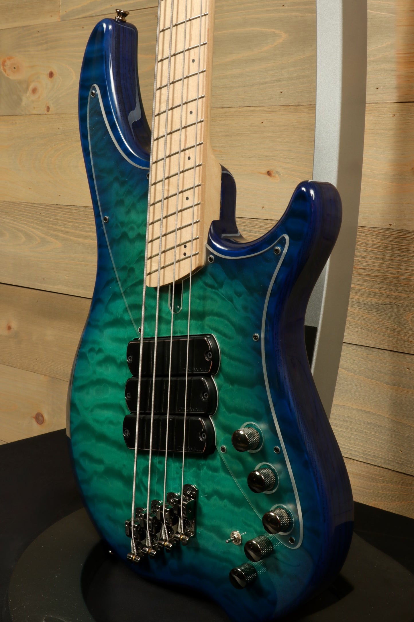 Dingwall Combustion Nashville bass guitar with blue-green quilted finish, side view