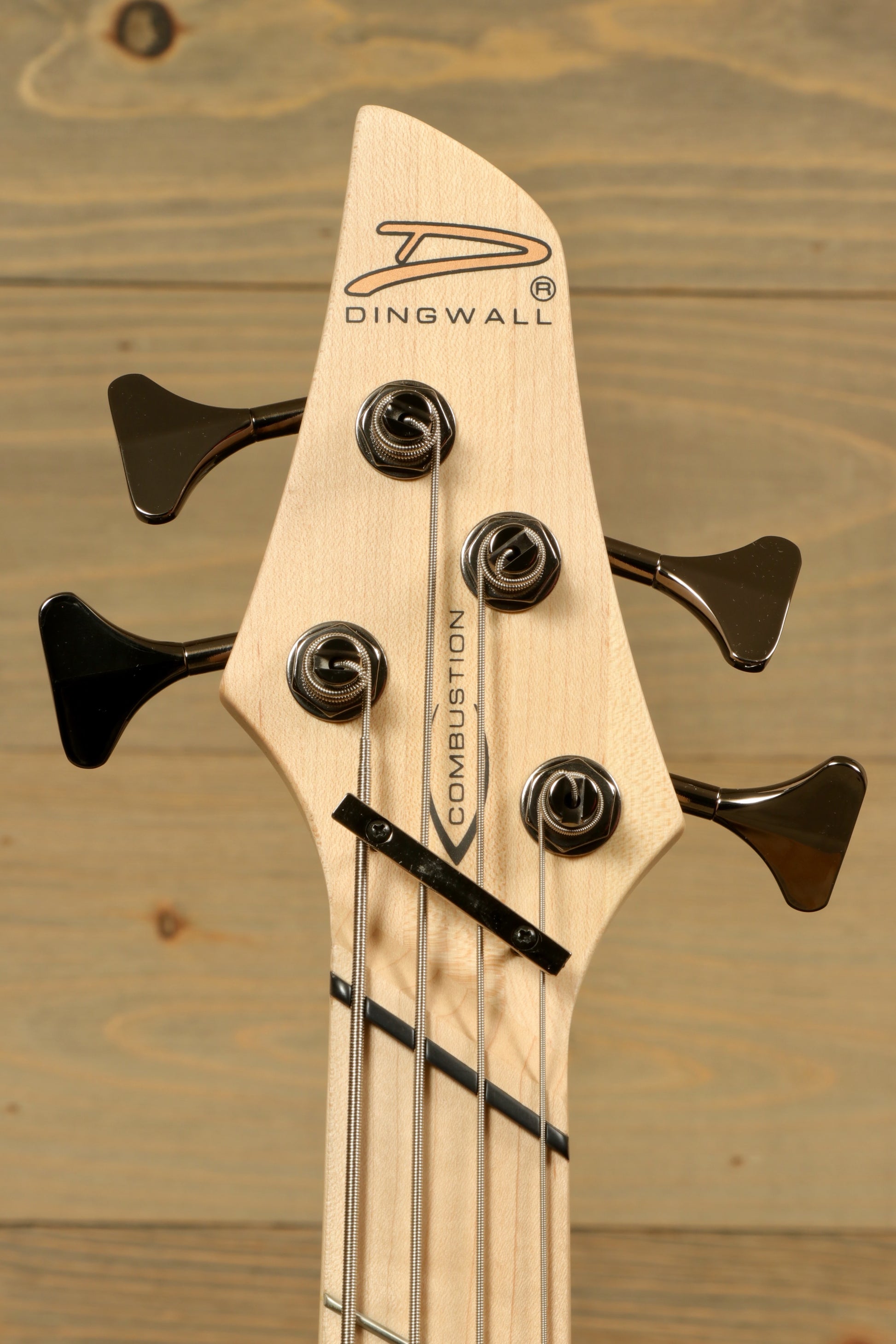 Dingwall Combustion Nashville bass guitar, natural wood finish, headstock view showing tuning pegs