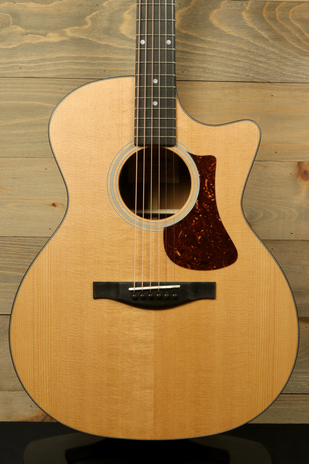 Eastman AC122-1CE acoustic electric guitar in natural finish, front view showcasing the body and soundhole