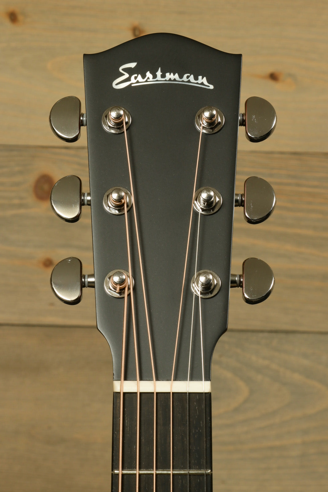 Eastman AC122-1CE acoustic electric guitar headstock, black finish with tuning pegs