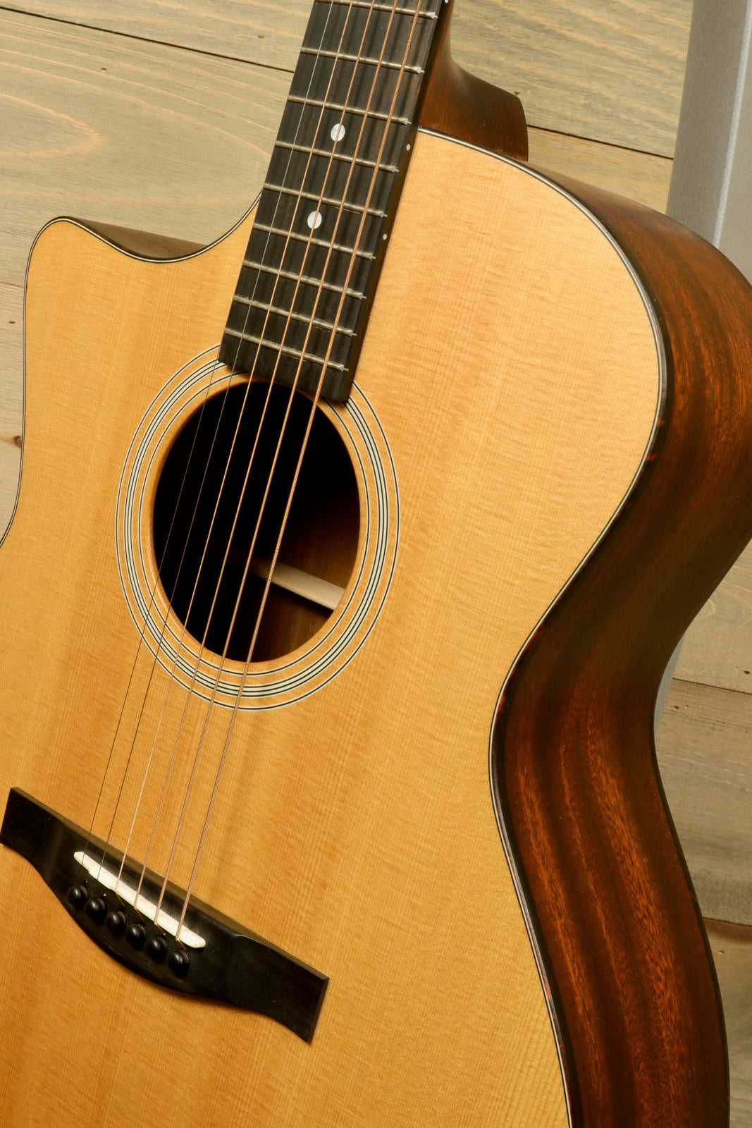 Eastman AC122L-1CE acoustic electric guitar, natural finish, front view showcasing the body and strings