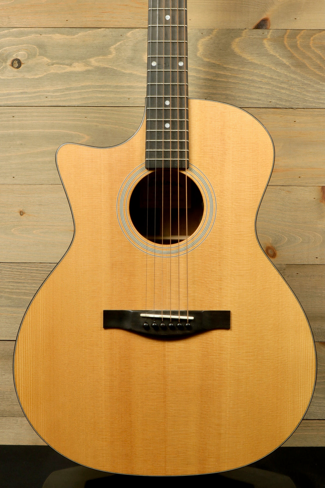Eastman AC122L-1CE acoustic electric guitar in natural finish, front view with visible strings and fretboard.