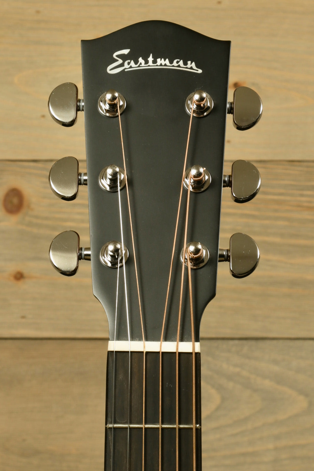 Eastman AC122L-1CE acoustic electric guitar headstock with chrome tuners and black finish