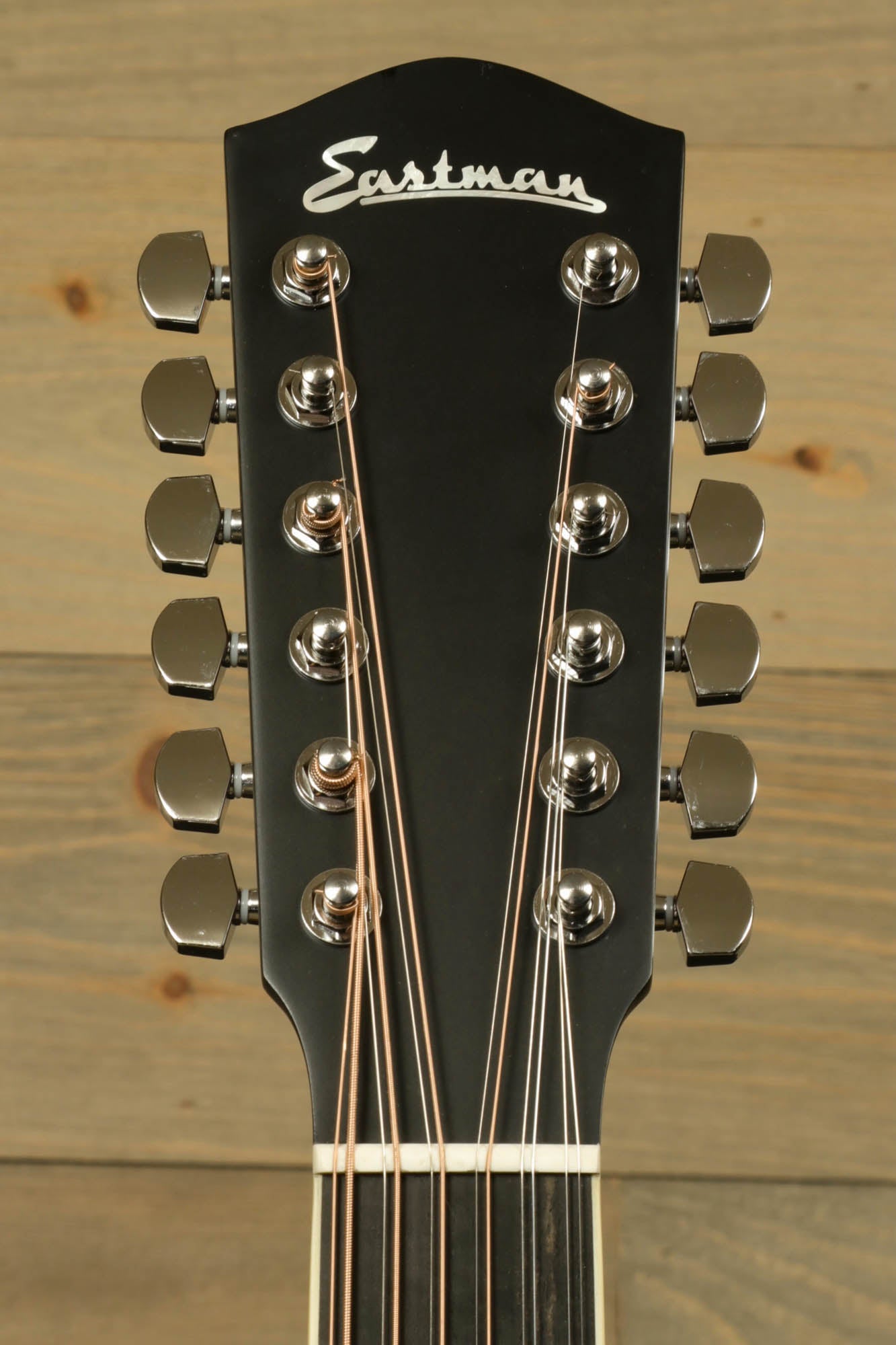 Eastman AC330E-12 12-string acoustic guitar headstock featuring 12 tuning pegs and elegant design