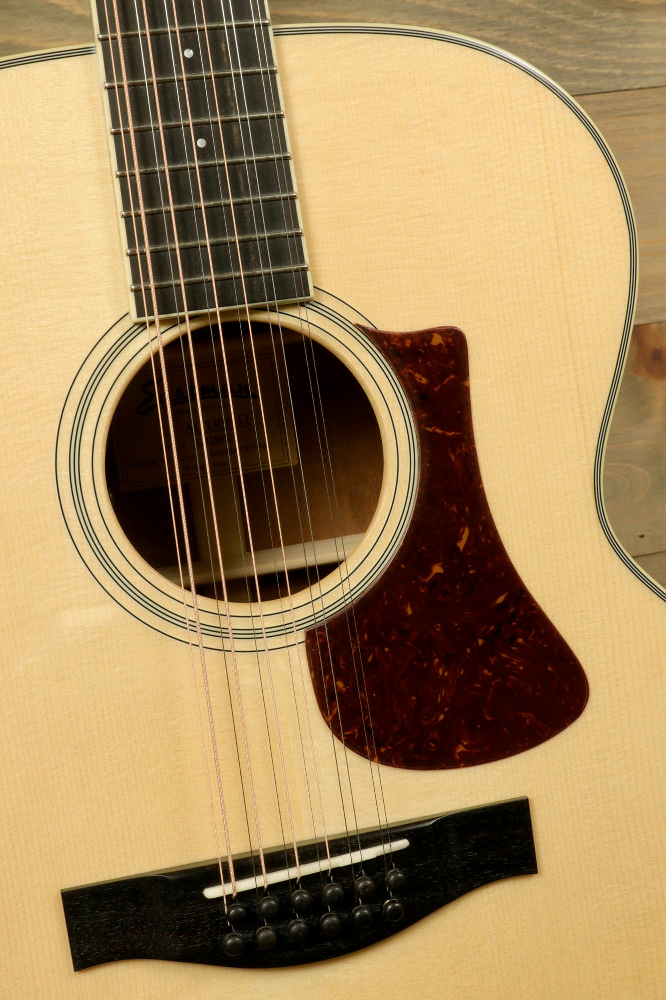 Close-up of Eastman AC330E-12 12-string acoustic guitar with beautiful wood grain and sleek design