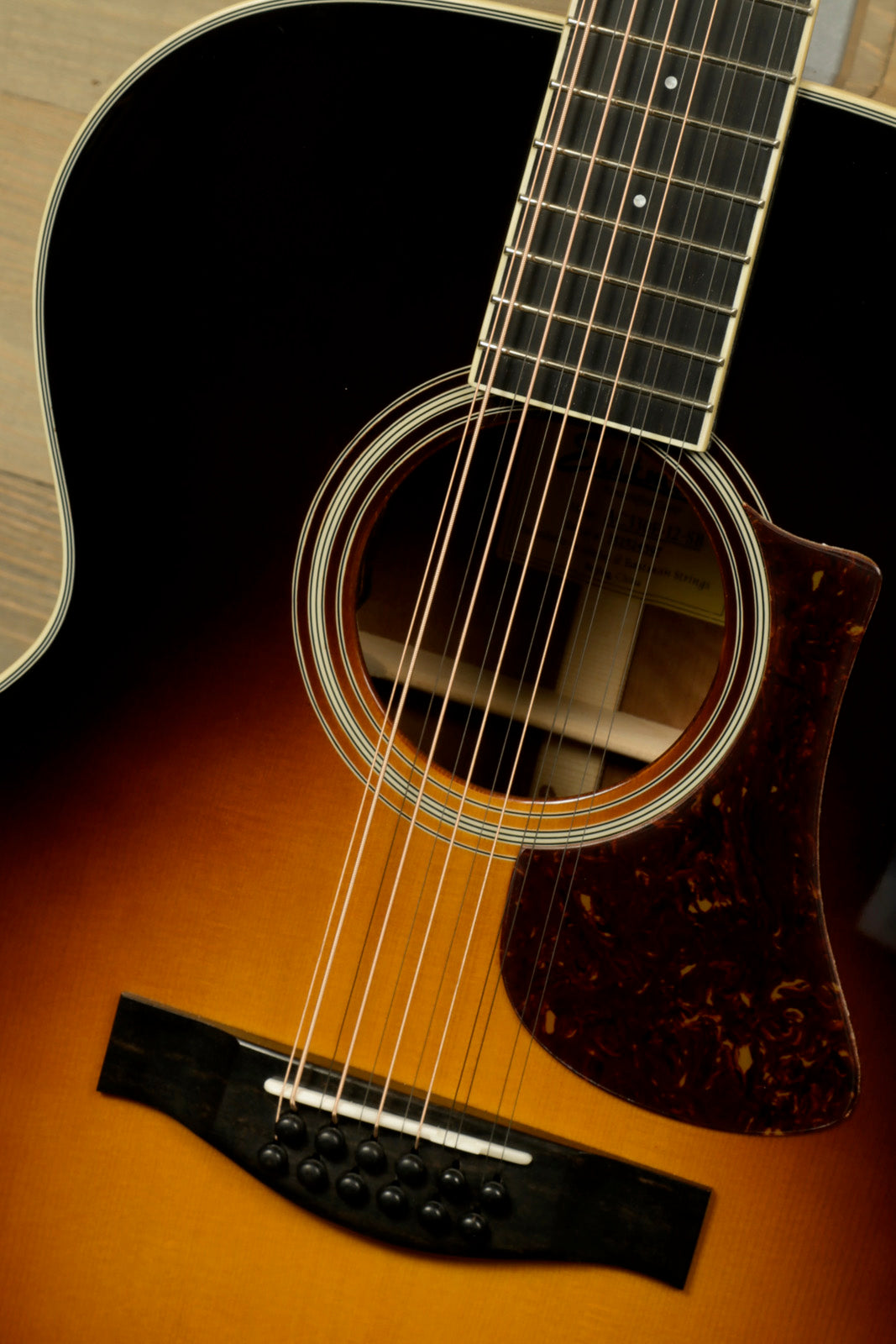 Eastman AC330E-12-SB 12-string acoustic guitar with a sunburst finish and detailed soundhole design